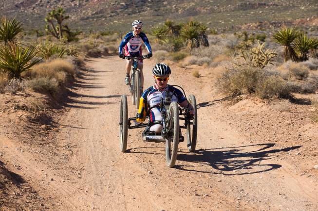 29 year-old Staff Sergeant Tim Brown, a USMC Explosive Ordnance Disposal Specialist, navigates through Blue Diamond on a 3-wheel hand-powered mountain bike, built by Bill Lasher of Las Vegas, during the Ride 2 Recovery Las Vegas Mountain Bike Challenge Monday, Jan. 27, 2014. Brown, who lost 3 limbs during a roadside bomb attack in Afghanistan in Oct. of 2011, is among many wounded veterans who are being helped by Ride 2 Recovery, a nonprofit organization that provides rehabilitation to injured veterans through cycling.